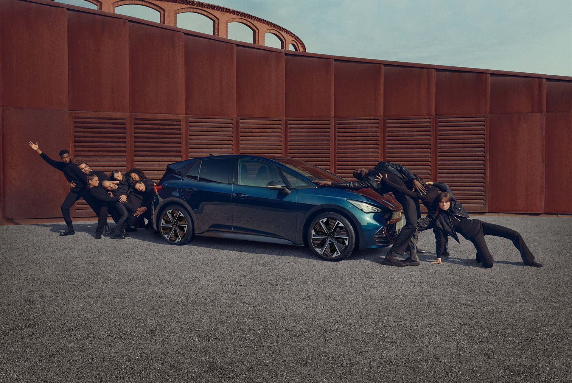 People posing on CUPRA Born Aurora Blue colour